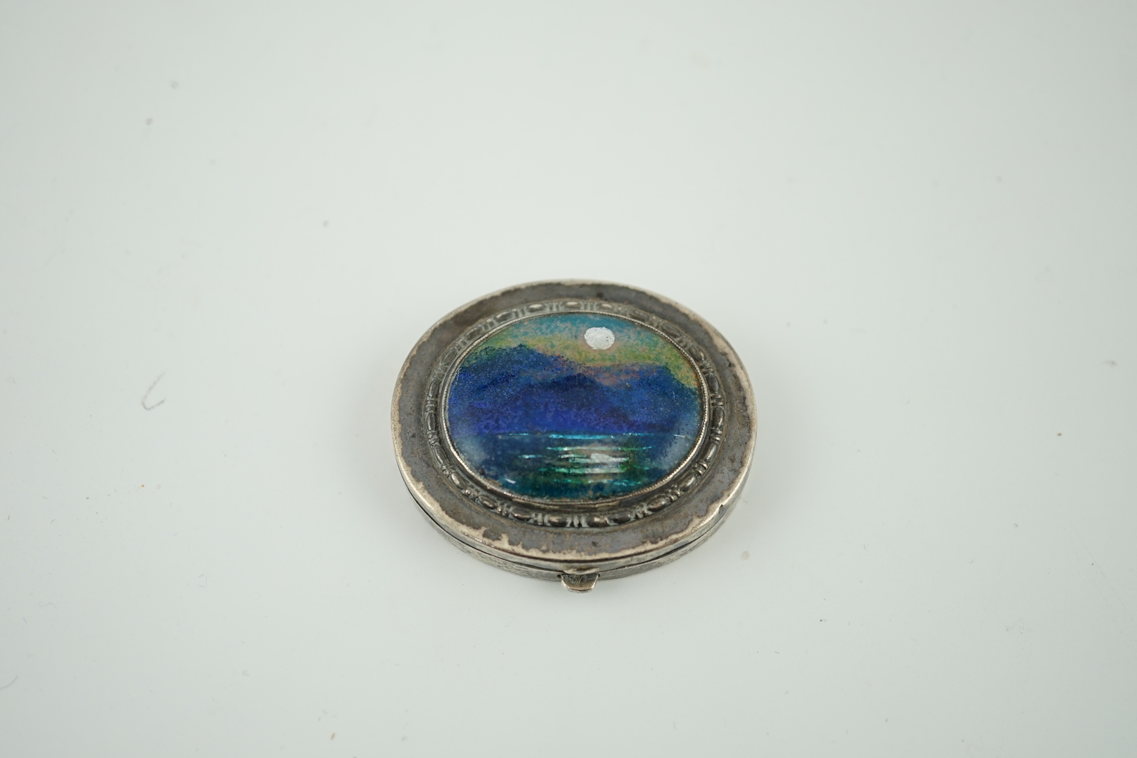 A George V Arts & Crafts Liberty & Co silver and enamel oval pill box, with hinged cover, Birmingham, 1929